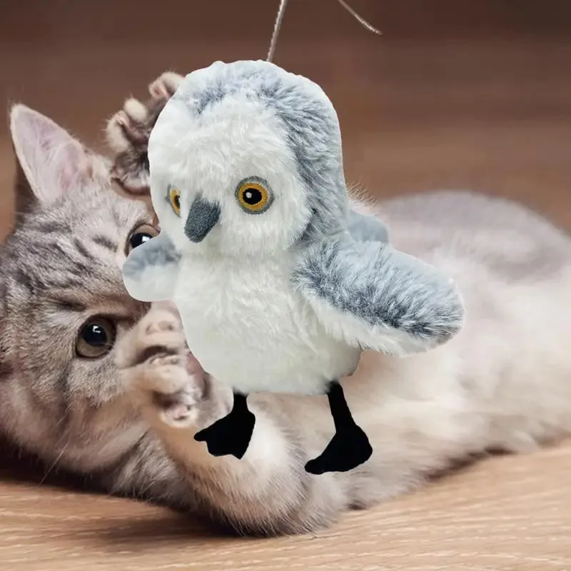 Cat playing with a flapping plush owl toy