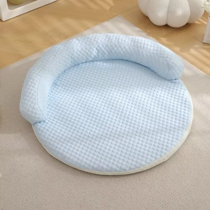 Round cooling dog bed with a pale grey cover and bolster