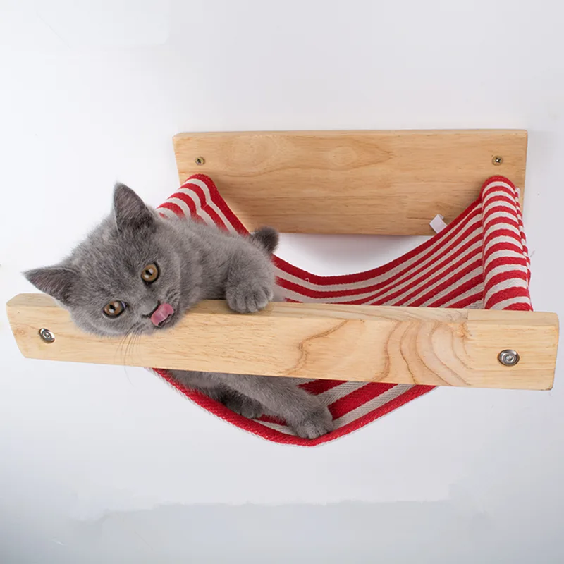 Grey cat resting its chin on the wooden rail of a red striped wall hammock