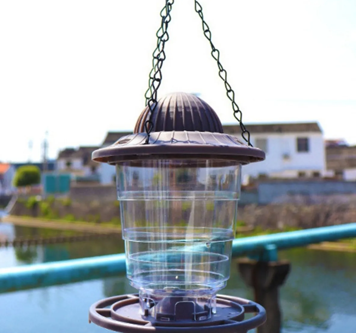 Squirrel-resistant Hanging Feeder hanging outdoors by a canal