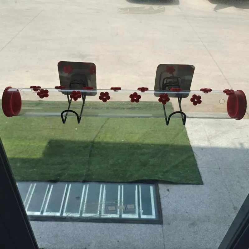 Hummingbird Window Feeder fixed to glass with suction-cup brackets