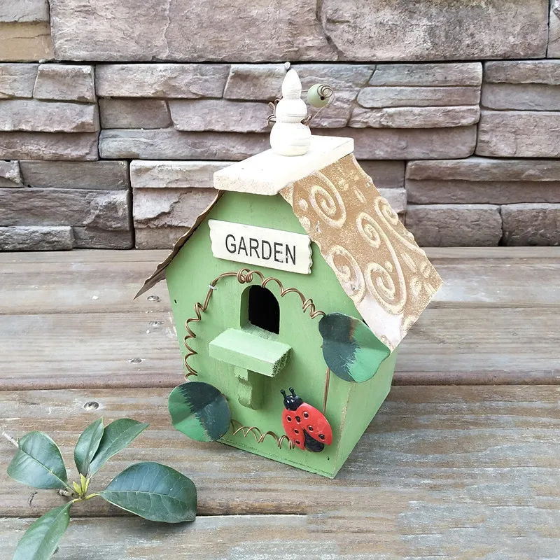 Rustic wooden bird house with a blue roof