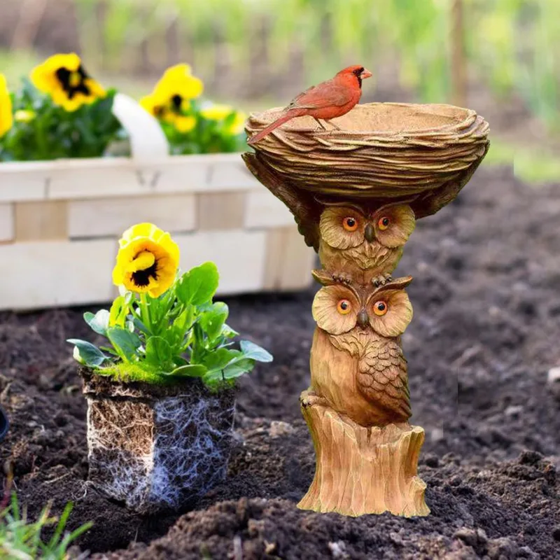 Owl pedestal bird bath among flowers
