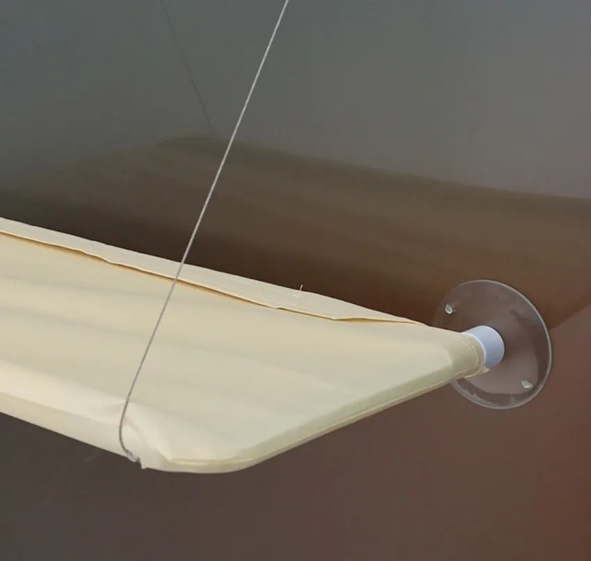 Close-up of the Cat Window Perch fabric bed and suction cup fixed to a window