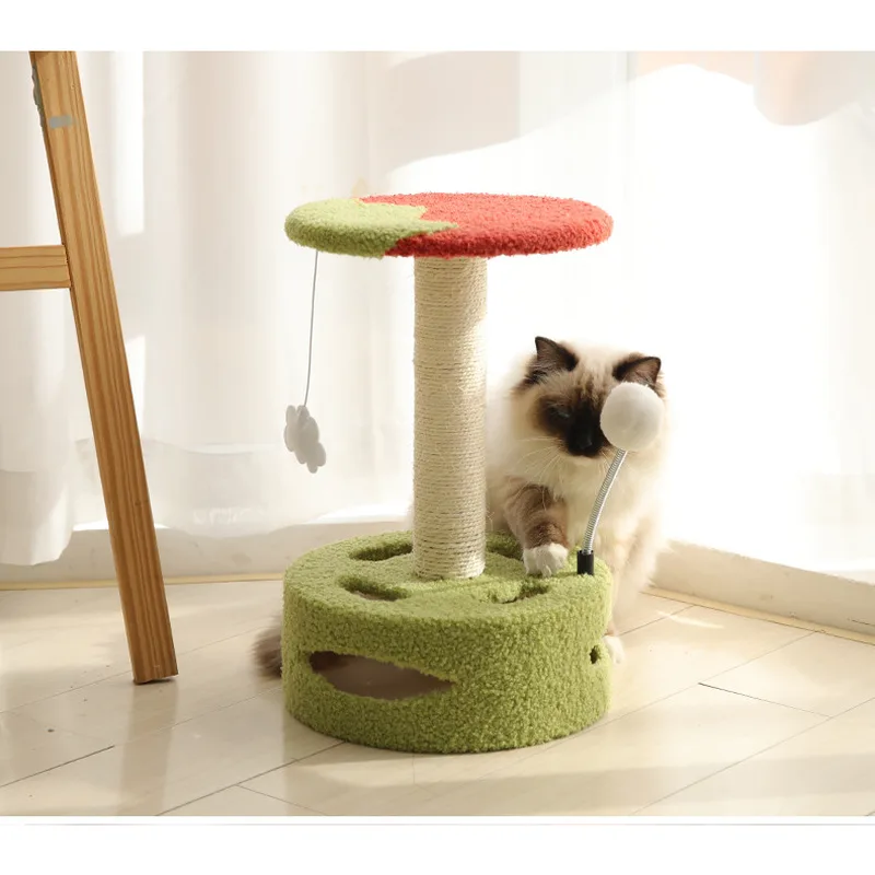 Cat lying beside a mini cat tree with a sisal post